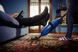 Photo: man relaxing while woman doing chores at home man relaxing while woman doing chores at home
