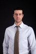Serious businessman isolated on black