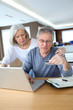 Senior couple making secured payment on internet