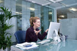 Photo: Stressed businesswoman at desk in office Stressed businesswoman at desk in office