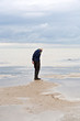 man walking in tidal flat