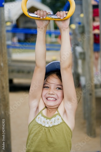 Photo: Girl Hanging From Playground Ride Girl Hanging From Playground Ride