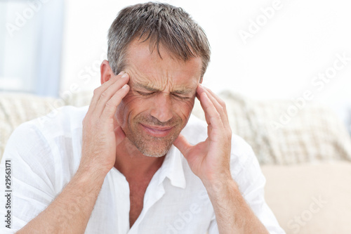 Photo: Man having a headache at home Man having a headache at home