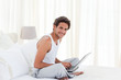 Photo: Man working on his laptop at home Man working on his laptop at home