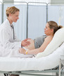 Photo: Nurse reassuring her pregnant patient Nurse reassuring her pregnant patient