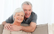 Photo: Lovers hugging while they are looking at the camera Lovers hugging while they are looking at the camera