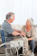 Photo: Woman with her husband in a wheelchair Woman with her husband in a wheelchair