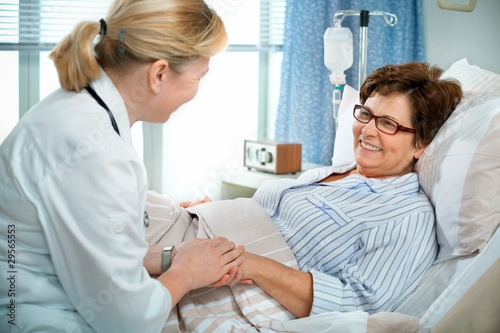 Photo: doctor or nurse talking to patient in hospital doctor or nurse talking to patient in hospital