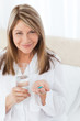 Photo: Sick woman taking her pills at home Sick woman taking her pills at home