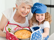 Photo: A little girl with her grandmother looking at the camera A little girl with her grandmother looking at the camera