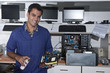 computer technician with motherboard at workshop