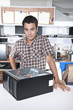 Photo : Happy owner of a computer repair store Happy owner of a computer repair store