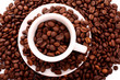 Small white cup of coffee with coffee grain on grain background