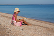 Girl child reads a book at the beach Girl child reads a book at the beach