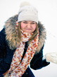 Happy young woman plays with a snow