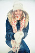 Happy young woman plays with a snow