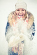 Happy young woman plays with a snow