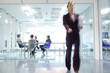 Businesswoman walking away from conference room