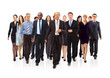 Happy young businessman standing in front of her team