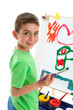 Photo: Young boy artist painting at easel Young boy artist painting at easel