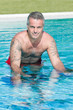 Healthy fitness man doing aqua bike in swimming pool