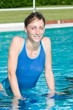 Happy young woman exercising with aqua bike
