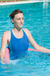 Beautiful lady with aqua tube in swimming pool