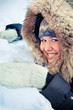 Happy young woman plays with a snow