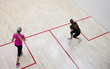 Two female squash players in fast action on a squash court (moti Two female squash players in fast action on a squash court (moti
