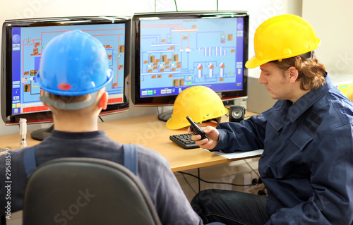 Photo: Two Workers in a Control room Two Workers in a Control room