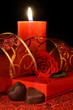 Valentine's chocolate hearts, rose and burning candle. Valentine's chocolate hearts, rose and burning candle.