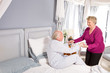 Woman helping her husband to get up