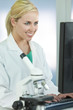 Female Scientist or Doctor Using Computer In Laboratory