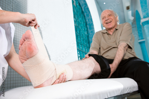 Photo: Senior man with hurted leg Senior man with hurted leg