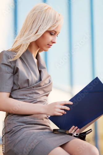 Photo: Young businesswoman with a folder Young businesswoman with a folder