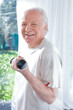 Senior man exercising with a dumbbell