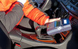 Credit card reader in taxi drivers hand in car Credit card reader in taxi drivers hand in car