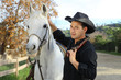 Cowboy petting his horse