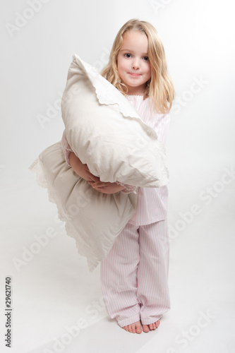Photo: Little girl holding a pillow Little girl holding a pillow