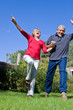 Happy elder couple jumping