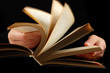 Open book in hands Open book in hands