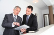 Sales people working on electronic tablet