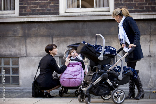 Photo: Two mothers with buggies meeting in the street Two mothers with buggies meeting in the street