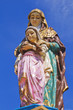 Statue of the Virgin. Blue background.