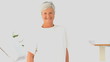 Elderly woman looking at the camera in a white living room