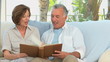 Video: Senior couple looking at a book Senior couple looking at a book