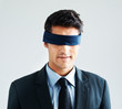 Young businessman wearing blindfold