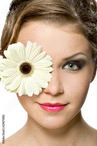 Photo: young girl with white gerber in front of her head young girl with white gerber in front of her head