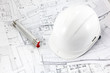 Blueprints helmet and meter at the construction site Blueprints helmet and meter at the construction site