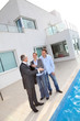 Couple visiting luxury villa with real-estate agent